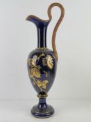 A large blue ground and gilded ewer, a/f, marked to base P.E Peret Dellores. Naive repair.