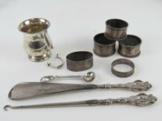 A pair of HM silver napkin rings together with three other silver napkin rings,