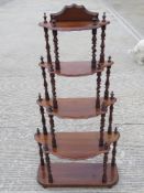 A late Victorian five sectional graduating what-not raised over turned supports, 127cm high.