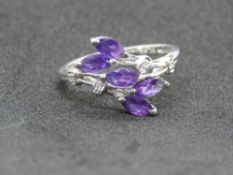 A 9ct white gold and amethyst ring having five marquise stones in floral spray setting,