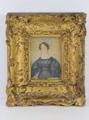 A late 18th early 19th century miniature watercolour portrait on paper of a woman in lace and