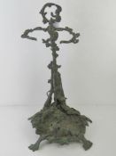 A cast brass stick stand in hunting theme having hound to front, gun and hare to back,