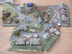 Two model village layouts including buildings, farm, church etc. In three sections.