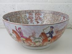 A large Chinese Export famille rose hunting scene punchbowl having men on horse back with pack of