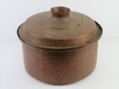 A large copper lidded cooking pot approx 38cm dia.