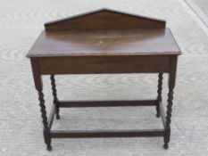 A barleytwist pier table having sloping backboard, 90 x 44 x 90cm.