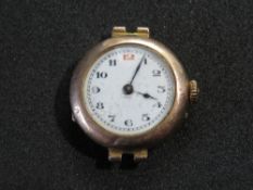 A 9ct gold ladies wristwatch, white enamel dial with red and black numerals,
