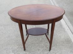 A delightful Edwardian oval planter table, crossbanded and strung with boxwood,