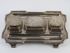 An HM silver partners desk type standish having pen tray to each side with central stamp tray and