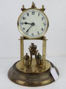 A brass clock on stand having white enamel dial, blue steel hands, a/f, dome deficient.