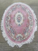 An oval woolen rug 148 x 210cm.