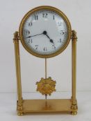 A brass mantel clock having white enamel dial with blue steel hands with pendulum,