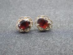 A pair of garnet earrings, filigree frame, with 9ct gold butterfly backs, indistinct marks to stud.
