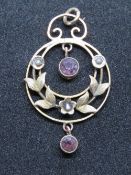 A late Victorian early Edwardian 9ct gold amethyst and seed pearl pendant, stamped 9ct.