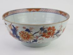 A large blue glazed punchbowl having Chinese floral and exotic bird decoration upon,