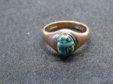 A 9ct rose gold signet ring set with a stone carved scarab beetle, hallmarked 375, size M, 4.