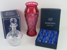 A large cranberry glass vase having floral design upon and standing 30cm high,