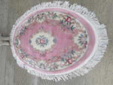 An oval woolen rug 148 x 210cm.