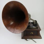 An HMV table top wind up gramophone with handle, wooden detachable horn and gramola stylus.
