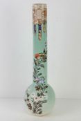 A tall Japanese Meiji period vase handpainted bird and floral decoration upon a pale green ground,