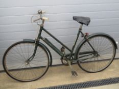 A smart ladies Triumph bicycle with mud guards, integral pump bell and rear light,