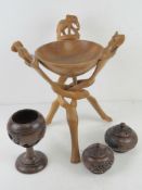 A quantity of hand carved wooden African items inc bowl on triform stand,