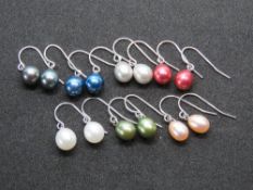 Seven pairs of coloured pearl earrings.