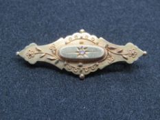 A 15ct gold Victorian brooch having glazed mourning locket to back,