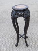 A late 19th century oriental hardwood planter stand having inset rouge marble top,