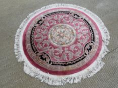 A round woolen rug, 146cm dia.