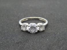 A 15ct white gold trilogy ring, three graduated white 'Diamonique' stones, hallmarked 585,