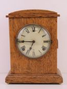 An oak cased mantle clock having white dial marked 'Made in United States of America by WH. L.