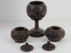 A quantity of hand carved wooden African items inc bowl on triform stand,