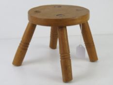 A small pine four-legged stool, 21cm dia.