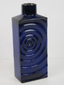 A square shaped vase in blue with circular pattern upon, marked to base '215/25'.