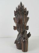 A Balinese carved wooden figurine of a goddess, 21cm high.