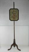 A vintage tapestry pole fire screen having floral basket in glazed octagonal frame, frame 28 x 36cm,