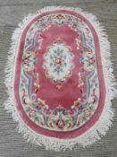 An oval woolen rug, 115 x 120cm.