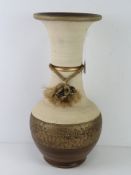 A contemporary plaster vase in cream and brown ground, 51cm high.