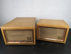 A portable record player with matching speaker by HMV.