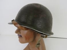A WWII US M1 helmet, front seam,