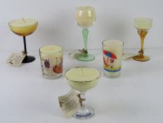 Six assorted handmade candles using vintage coloured glass wine glasses and champagne saucers etc.