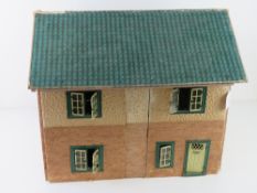 A mid to late 20thC dolls house having opening windows and door, some furniture within, 50cm wide.