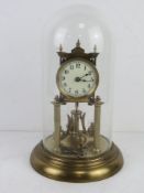 A brass mantle clock in glass dome having enamel dial, with key, all standing 31.5cm high.