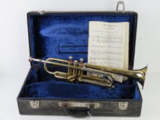 A brass trumpet with silvered mouth piece engraved B&M Champion no 2239 in fitted case.
