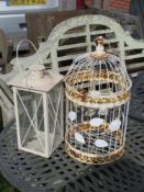 A white painted 'bird cage' and a large white painted lantern.