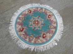 A round woolen rug, 127cm dia.