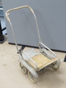 A vintage collapsible dolls pram.