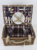 A wicker picnic hamper for two including cutlery, plates and plastic glasses, 41 x 27 x 18cm.