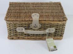 An as new wicker picnic hamper for two including thermal lining, cutlery, plates, bottle opener,